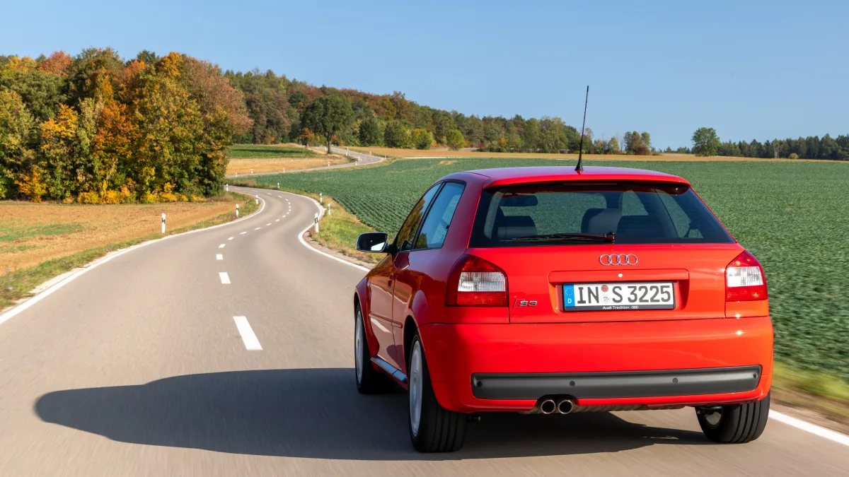 Czerwone Audi S3 8L pierwszej generacji widziane z tyłu na krętej drodze