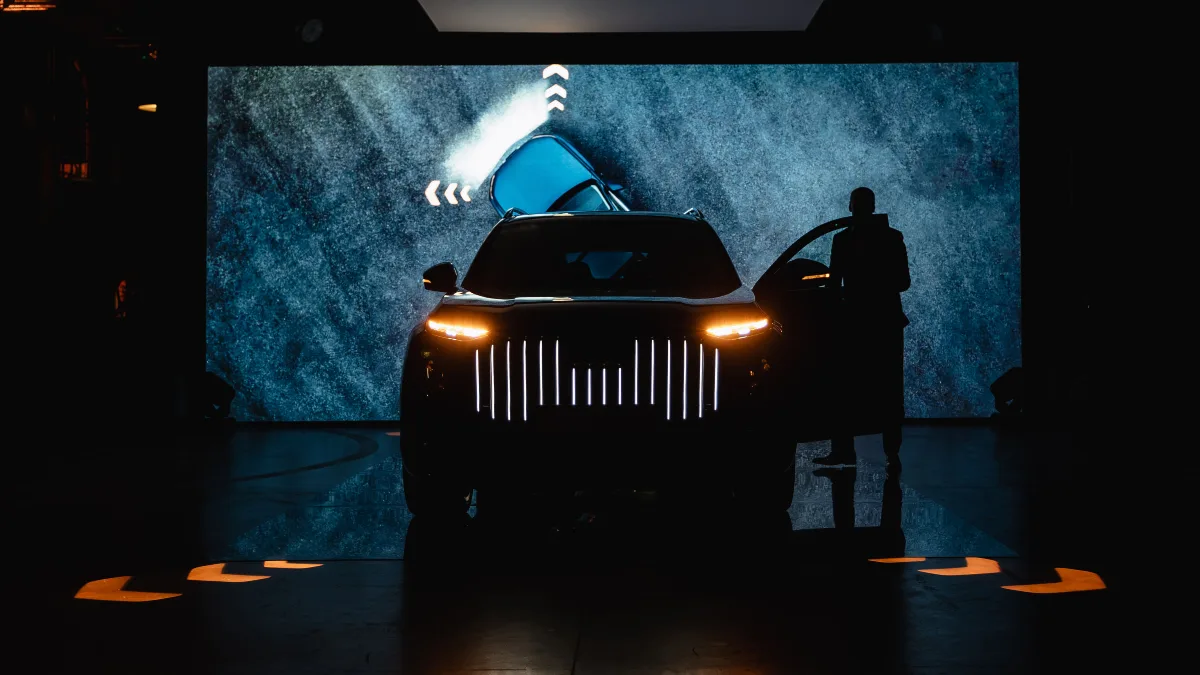 Audi Q9 z podświetlanym grillem i włączonymi kierunkowskazami na scenie