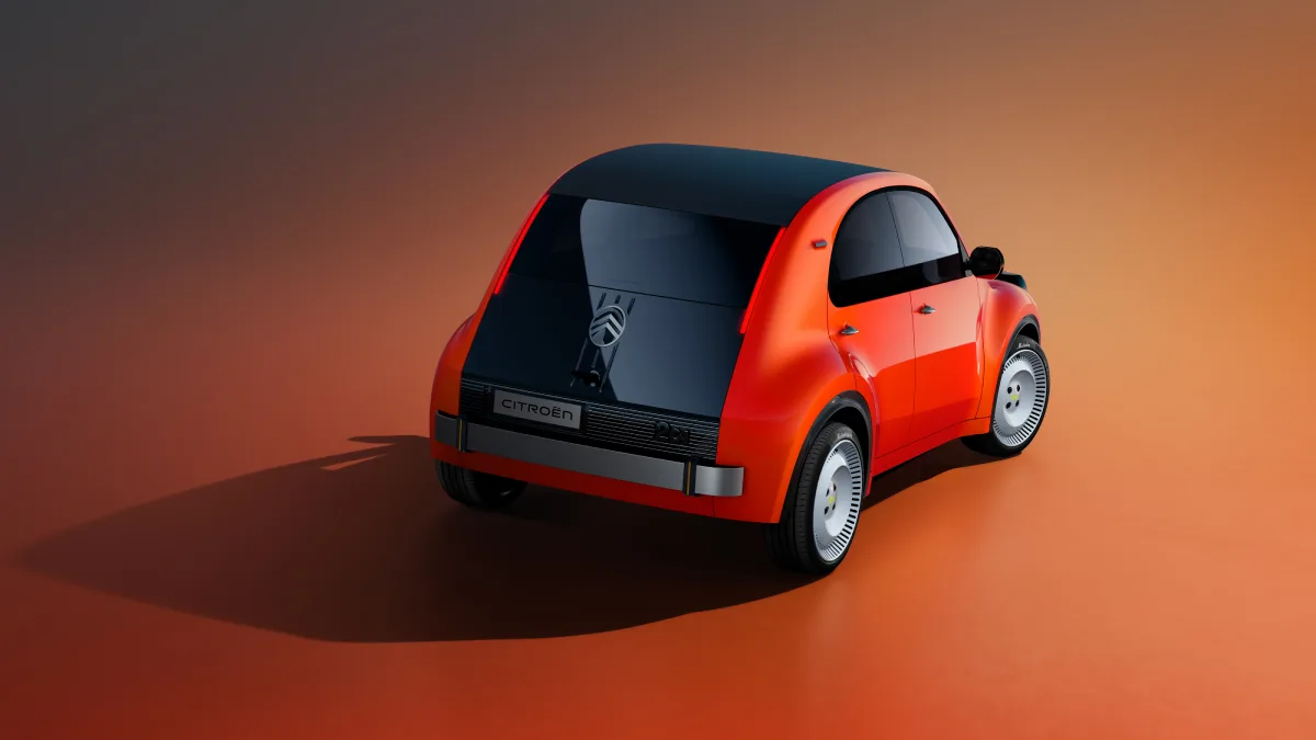 Pomarańczowy Citroën 2 CV Concept widziany od tyłu i prawego boku, z dużą czarną klapą bagażnika