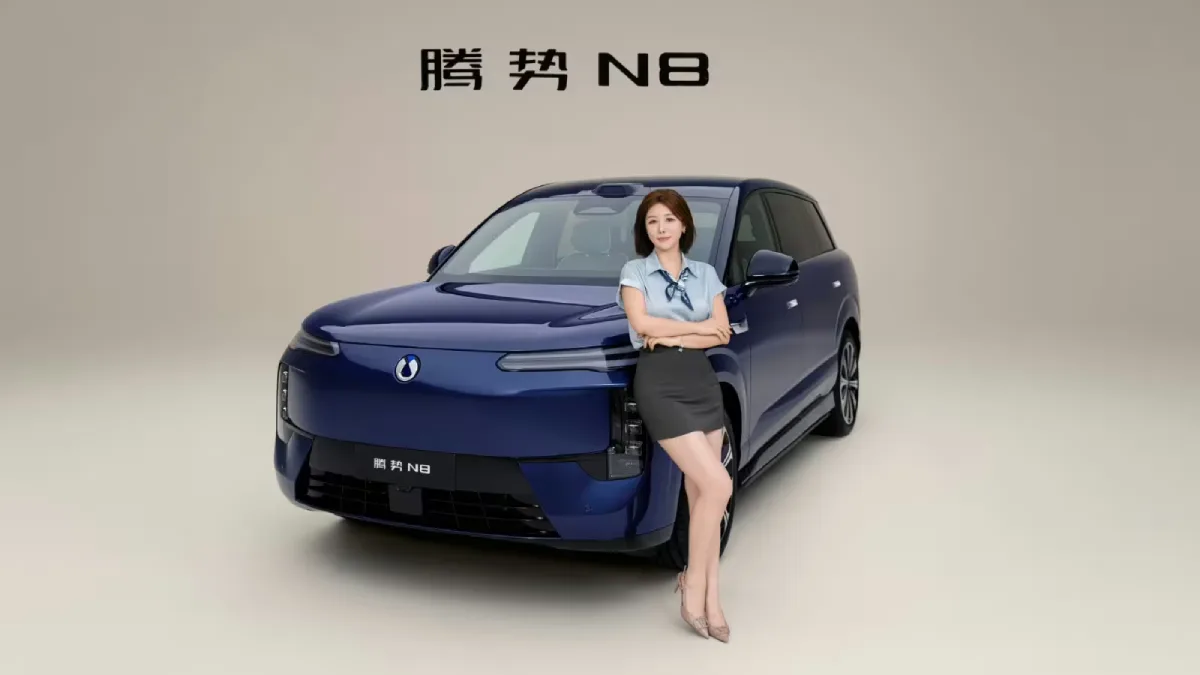 Denza N8 EV 2026, granatowy elektryczny SUV widziany z przodu pod kątem, z modelką stojącą przy samochodzie