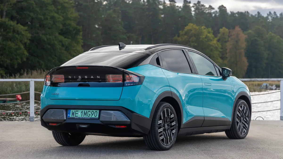 Turkusowy Nissan LEAF 2026 widziany od tyłu pod kątem, z czarną klapą bagażnika, tylnymi lampami LED i polską tablicą rejestracyjną