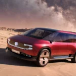 Renault E-Space Concept 2026 w czerwonym kolorze, widok przedniej i bocznej części elektrycznego vana na pustynnym tle